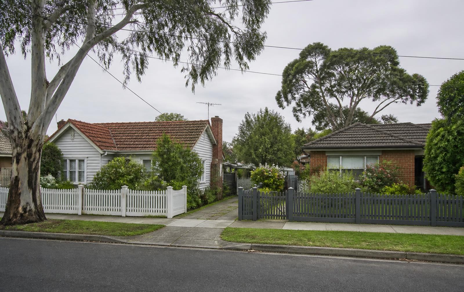 Family homes with front gardens on a quiet Victorian street